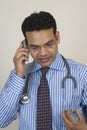 Young doctor talking on mobile phone