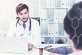 Young doctor talking to a patient in office