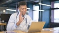 Young Doctor Thinking and Working on Laptop in Office Royalty Free Stock Photo