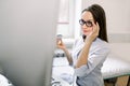 Young doctor with ultrasound scanner in hand, looking at the screen of modern ultrasound scanning machine, touching her Royalty Free Stock Photo