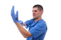 Young doctor in uniform getting ready to work putting on gloves isolated on a white background Royalty Free Stock Photo