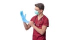 young doctor in uniform getting ready to work putting on gloves isolated on a white background Royalty Free Stock Photo