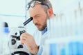 Young doctor in uniform working at testing laboratory at clinic