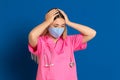 Young doctor wearing a mask face and a pink uniform Royalty Free Stock Photo