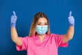 Young doctor wearing a mask face and a pink uniform Royalty Free Stock Photo