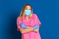 Young doctor wearing a mask face and a pink uniform Royalty Free Stock Photo