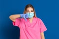 Young doctor wearing a mask face and a pink uniform Royalty Free Stock Photo