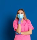 Young doctor wearing a mask face and a pink uniform Royalty Free Stock Photo