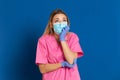 Young doctor wearing a mask face and a pink uniform Royalty Free Stock Photo