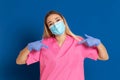 Young doctor wearing a mask face and a pink uniform Royalty Free Stock Photo