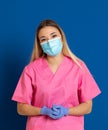 Young doctor wearing a mask face and a pink uniform Royalty Free Stock Photo