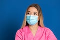 Young doctor wearing a mask face and a pink uniform Royalty Free Stock Photo