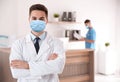 Young doctor wearing medical mask in clinic Royalty Free Stock Photo