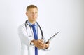 Young doctor in white coat with a stethoscope greets holding out his hand Royalty Free Stock Photo