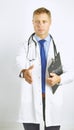 Young doctor in white coat with a stethoscope greets holding out his hand Royalty Free Stock Photo