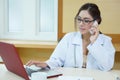 Young doctor woman speaking by phone mobile in her office Royalty Free Stock Photo