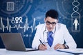 Young doctor working in front of laptop Royalty Free Stock Photo