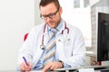 Young doctor writing medical prescription Royalty Free Stock Photo