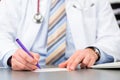 Young doctor writing medical prescription Royalty Free Stock Photo