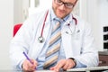 Young doctor writing medical prescription Royalty Free Stock Photo