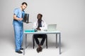 Young doctors discussing diagnosis in bright office. Two doctors disscusing xray at office table isolated on white background Royalty Free Stock Photo