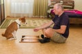 Young dog and mature man playing backgammon Royalty Free Stock Photo