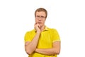 Young doubting man in glasses, man in yellow T-shirt isolated on white background Royalty Free Stock Photo