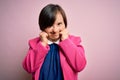 Young down syndrome business woman over pink background covering ears with fingers with annoyed expression for the noise of loud Royalty Free Stock Photo