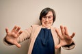 Young down syndrome business woman wearing glasses standing over isolated background afraid and terrified with fear expression Royalty Free Stock Photo