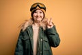 Young down syndrome woman wearing ski coat and glasses for winter weather smiling with happy face winking at the camera doing Royalty Free Stock Photo