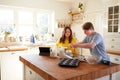 Young Downs Syndrome Couple Baking In Kitchen At Home