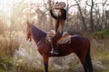 Young dreadded girl with her horse and shamanic frame drum. Royalty Free Stock Photo