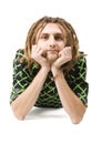 Young dreadlock man lies isolated Royalty Free Stock Photo