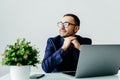 Young dreamy businessman in suit thinking of business vision outlook planning future project idea at work with laptop Royalty Free Stock Photo