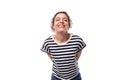 young dreamy well-groomed curly woman with black hair in a summer striped t-shirt