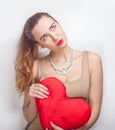 Young dreamy, woman looking right with heart in hands Royalty Free Stock Photo