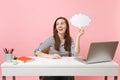 Young dreamy woman looking up holding empty blank Say cloud speech bubble sit and work at white desk with pc laptop Royalty Free Stock Photo