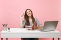 Young dreamy woman looking up thinking searching new idea holding pencil and notebook sit work at white desk with pc Royalty Free Stock Photo