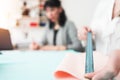 Young dressmaker woman measures the fabric with a ruler. Two seamstress working with cloth in design bureau. Small business