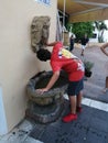 Young drinking in public fountain- Andalusia