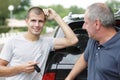 young driver holding cars key with senior man Royalty Free Stock Photo