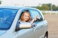 Young driver looking out of the car window holding a key Royalty Free Stock Photo