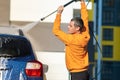 Young driver man washing his car with contactless high pressure water jet in self service car wash Royalty Free Stock Photo