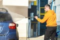 Young driver man washing his car with contactless high pressure water jet in self service car wash Royalty Free Stock Photo