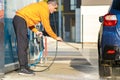 Young driver man washing his car with contactless high pressure water jet in self service car wash Royalty Free Stock Photo