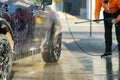 Young driver man washing his car with contactless high pressure water jet in self service car wash Royalty Free Stock Photo