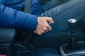 Young driver pulling the hand brake in car