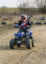 A young driver trains a ride on a small quad.