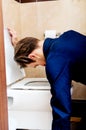 Young drunk or sick man vomiting