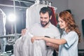 young dry cleaning workers scanning barcode on bag